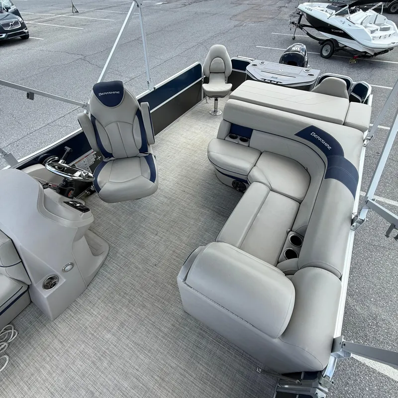 Slide: The Image of 2022 Berkshire 24RFC LE 2.75 pontoon boat interior with plush seating and steering console. - 10