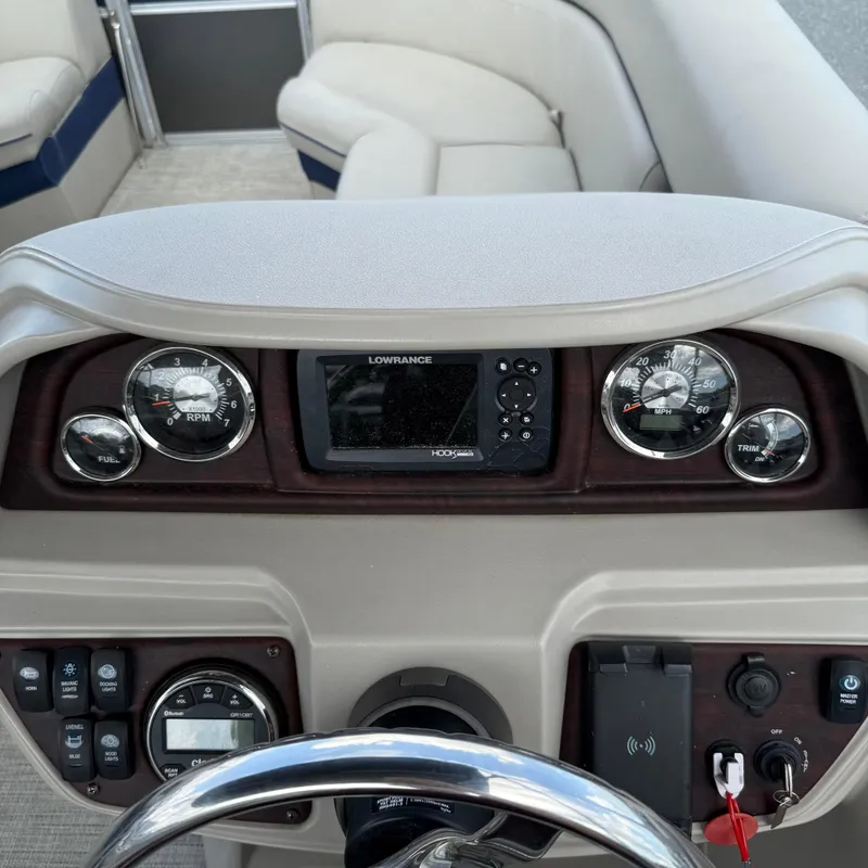 Slide: The Image of Dashboard of a 2022 Berkshire 24RFC LE 2.75 boat with gauges and controls. - 14