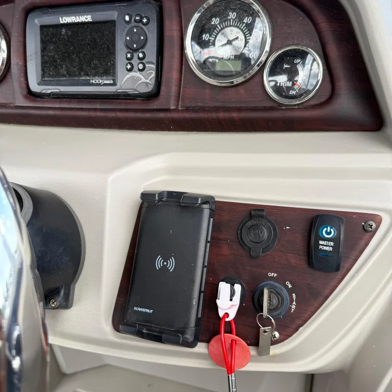 Slide: The Image of Control panel of a 2022 Berkshire 24RFC LE 2.75 boat with gauges and switches. - 16