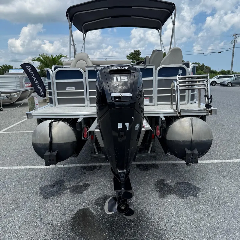 Slide: The Image of 2022 Berkshire 24RFC LE 2.75 pontoon boat with Mercury 115 engine, parked outdoors. - 6