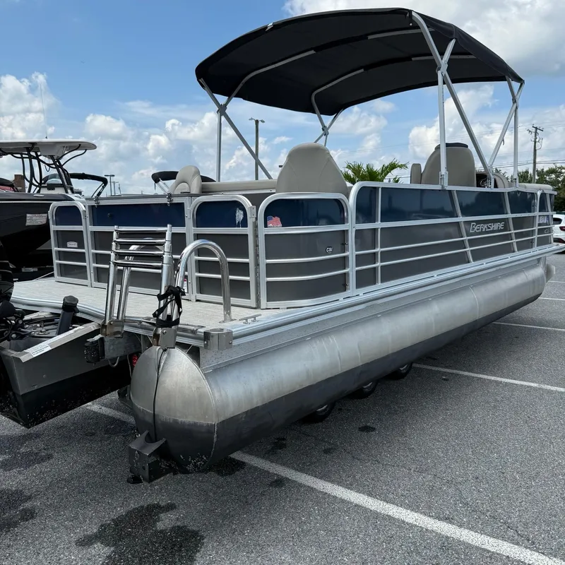Slide: The Image of 2022 Berkshire 24RFC LE 2.75 pontoon boat with canopy in parking lot. - 7