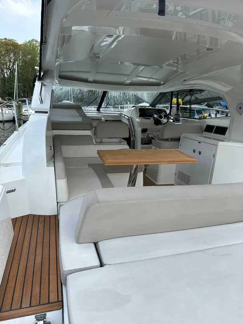 Slide: The Image of 2016 Jeanneau Leader 36 yacht interior with seating and wooden table. - 13