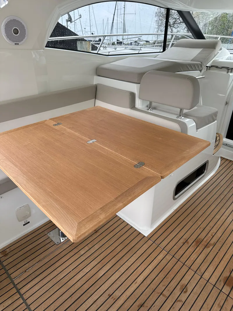 Slide: The Image of 2016 Jeanneau Leader 36 interior with wooden table and seating. - 21