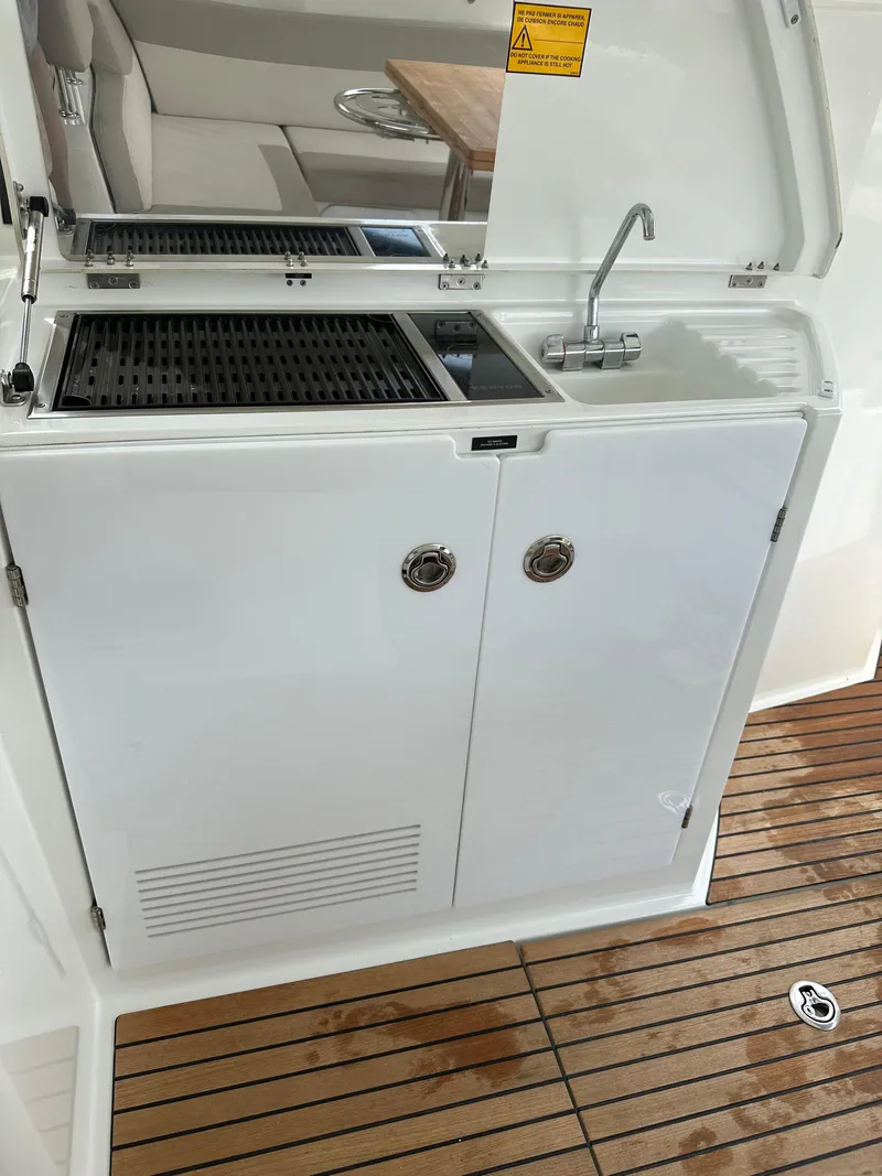 Slide: The Image of Outdoor kitchenette on 2016 Jeanneau Leader 36 yacht with sink and grill. - 24
