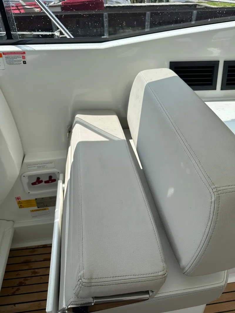 Slide: The Image of 2016 Jeanneau Leader 36 boat interior seating with white upholstery. - 31