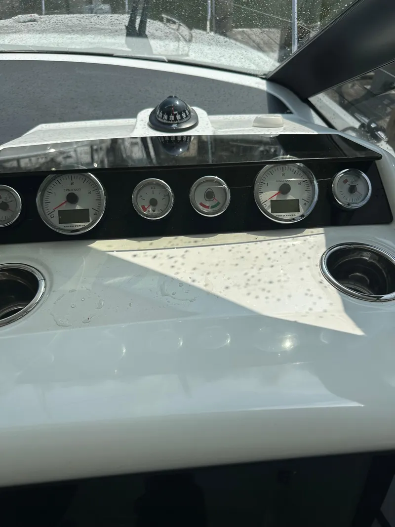 Slide: The Image of Dashboard of a 2016 Jeanneau Leader 36 boat with gauges and controls. - 35