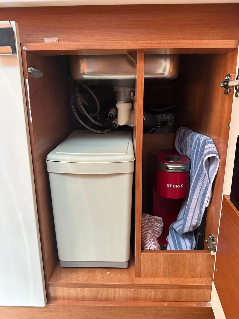 Slide: The Image of Under-sink storage in 2016 Jeanneau Leader 36 boat with trash bin and Keurig coffee maker. - 49