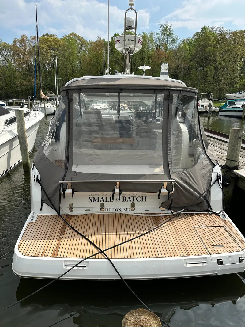 Slide: The Image of 2016 Jeanneau Leader 36 yacht docked at marina, rear view with canopy. - 9