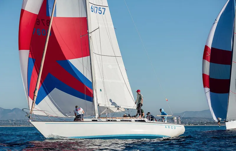 Slide: The Image of Sailboat Catalina 38, 1984 model, with colorful sails on open water. - 0