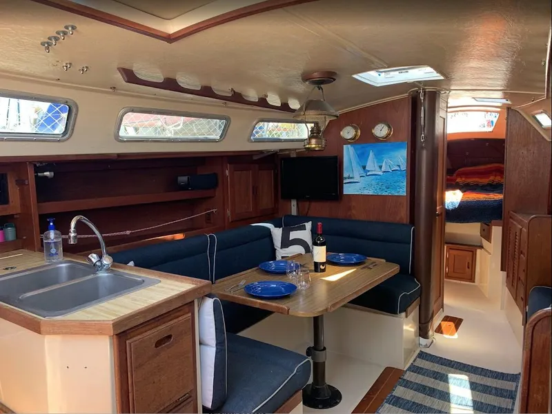 Slide: The Image of Interior of a 1984 Catalina 38 sailboat with cozy dining area and kitchenette. - 20