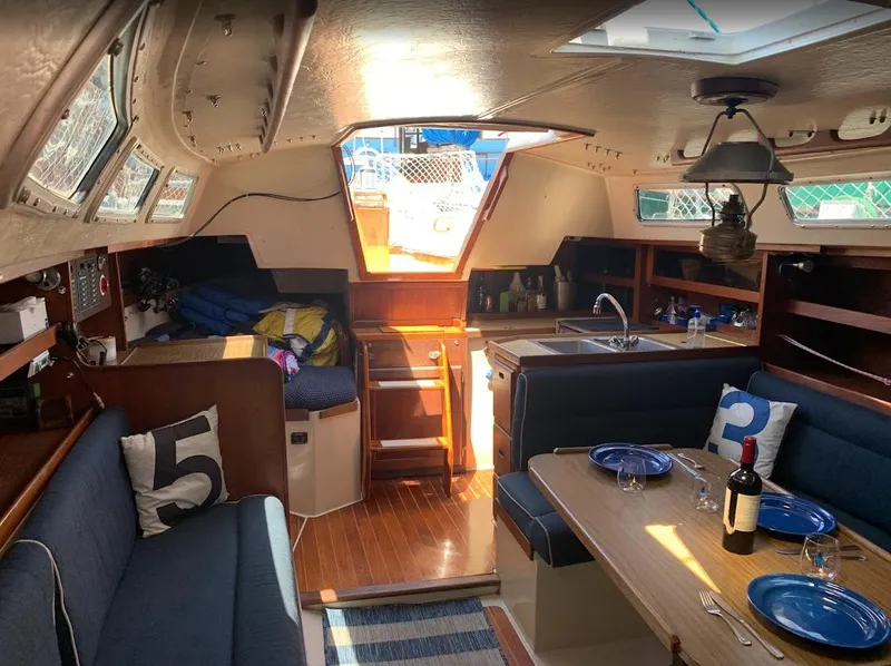 Slide: The Image of Interior of a 1984 Catalina 38 sailboat with cozy dining and kitchen area. - 21