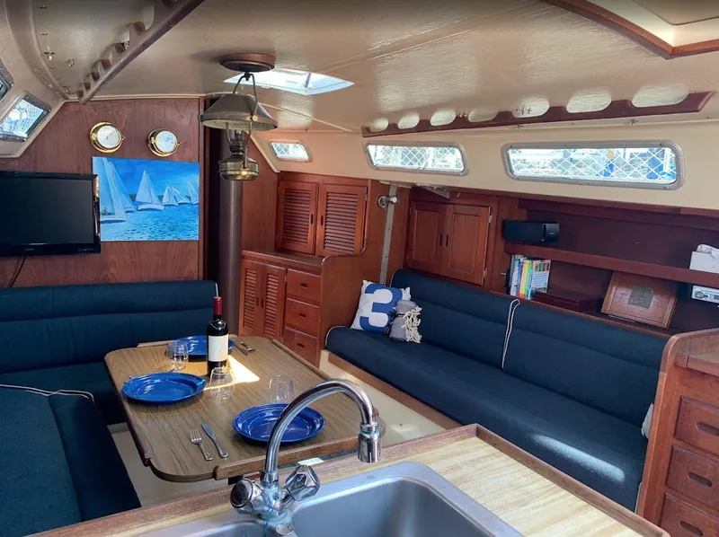 Slide: The Image of Interior of a 1984 Catalina 38 sailboat with cozy seating and dining area. - 28