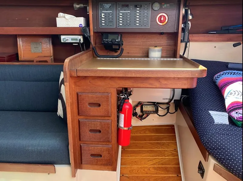 Slide: The Image of Interior of a 1984 Catalina 38 sailboat with navigation station and seating area. - 30