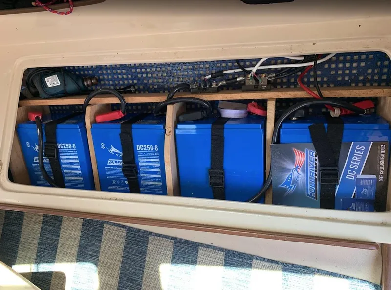 Slide: The Image of Four blue DC250-6 deep cycle batteries in a 1984 Catalina 38 boat compartment. - 32