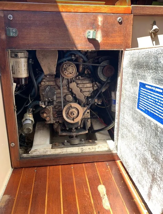 Slide: The Image of Engine compartment of a 1984 Catalina 38 sailboat, showcasing mechanical components. - 33