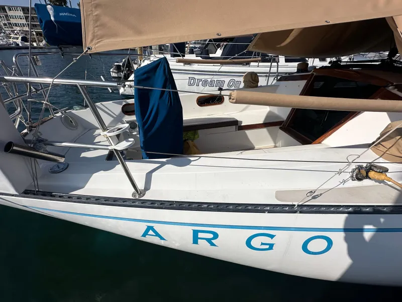 Slide: The Image of 1984 Catalina 38 sailboat named "ARGO" docked in a marina. - 4