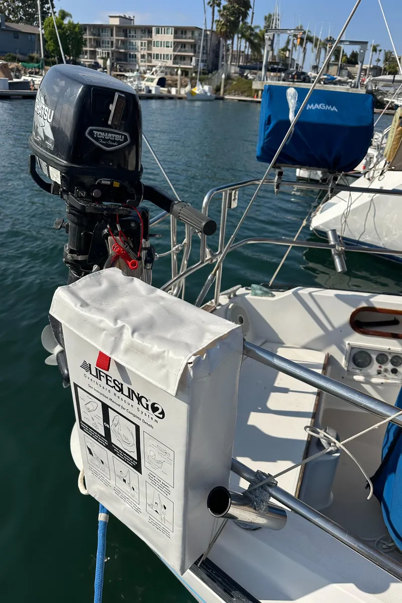 Slide: The Image of 1984 Catalina 38 sailboat with Tohatsu outboard motor and Lifesling 2 safety device. - 6