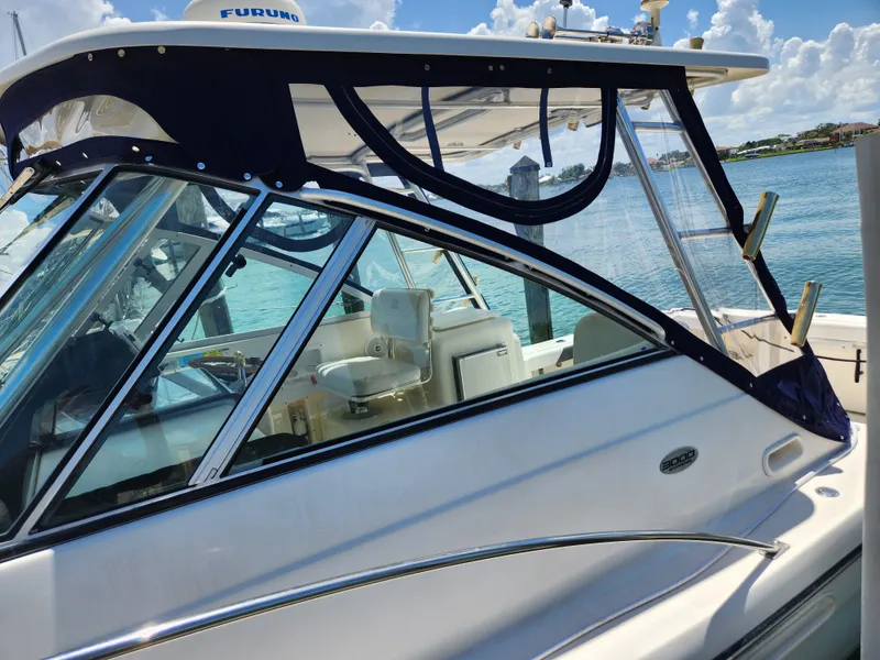 Slide: The Image of 2003 Pursuit 3000 Express boat docked by clear blue water. - 11