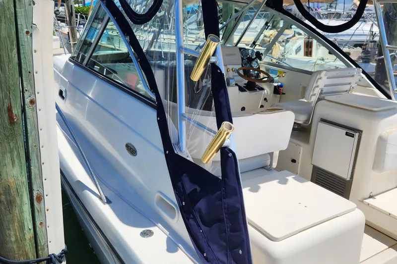 Slide: The Image of 2003 Pursuit 3000 Express boat interior with seating and control panel at dock. - 13