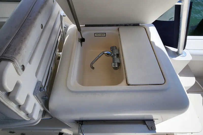 Slide: The Image of 2003 Pursuit 3000 Express boat sink with fresh water faucet. - 17