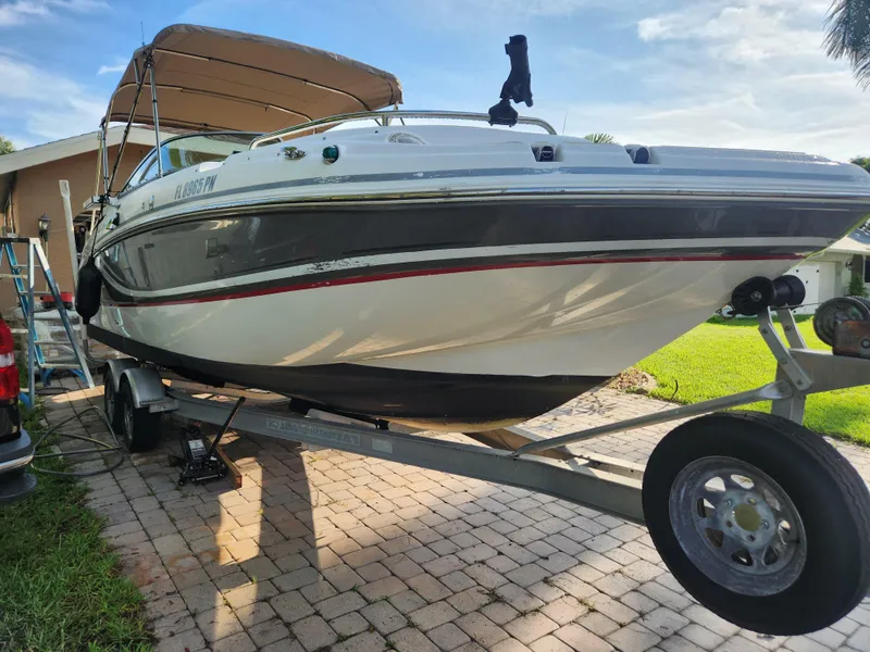 The Image of 2013 Hurricane SD2400 OB boat on trailer, parked on a paved driveway. - 1