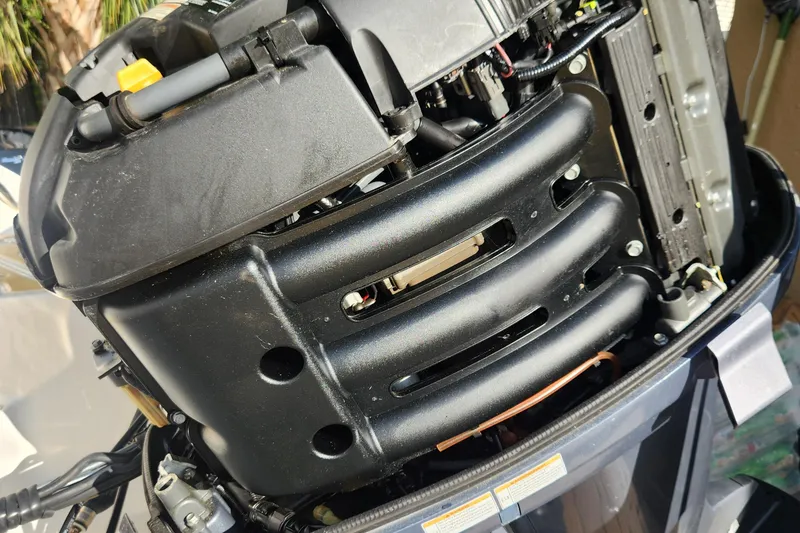 Slide: The Image of Close-up of a 2013 Hurricane SD2400 OB boat engine, showcasing intricate mechanical details. - 11