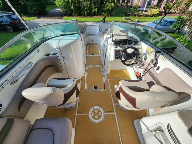 Slide: The Image of Interior of a 2013 Hurricane SD2400 OB boat with beige seating and steering console. - 12