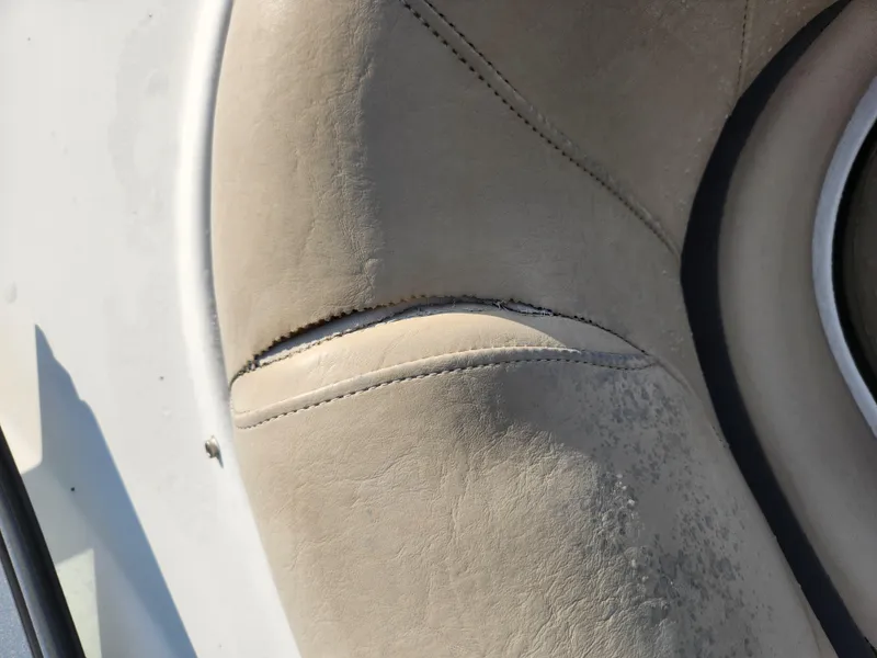 Slide: The Image of Torn beige upholstery on 2013 Hurricane SD2400 OB boat seat. - 15