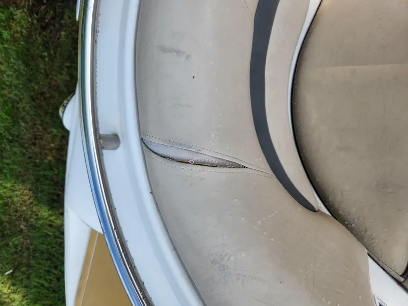 Slide: The Image of 2013 Hurricane SD2400 OB boat seat with visible wear and tear. - 16