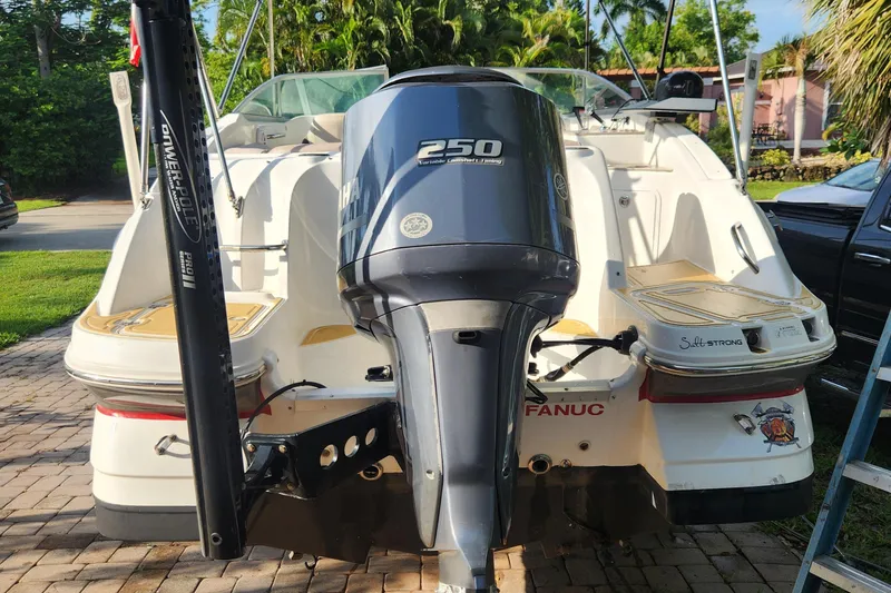 Slide: The Image of 2013 Hurricane SD2400 OB boat with Yamaha 250 engine, parked on a driveway. - 19