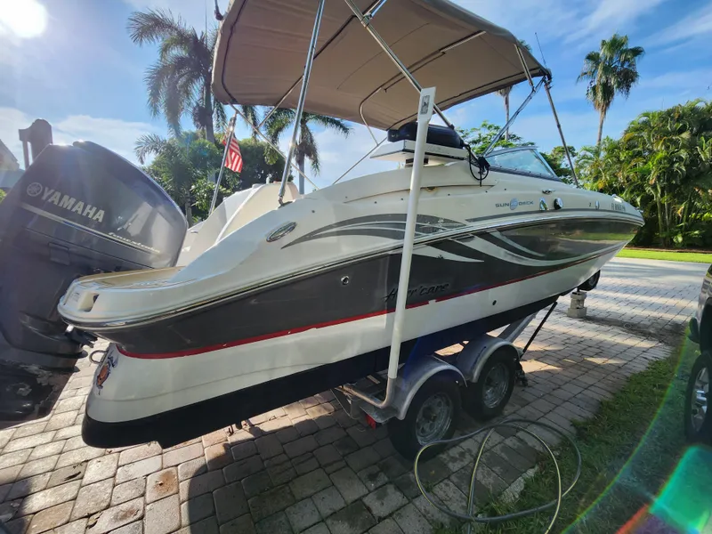 Slide: The Image of 2013 Hurricane SD2400 OB boat on trailer with Yamaha outboard motor, parked on a sunny driveway. - 4