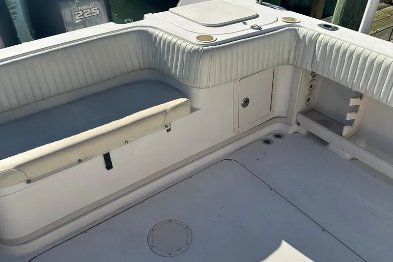 Slide: The Image of 2004 Grady-White Sailfish 282 WA boat interior with seating and Yamaha 225 engine. - 12