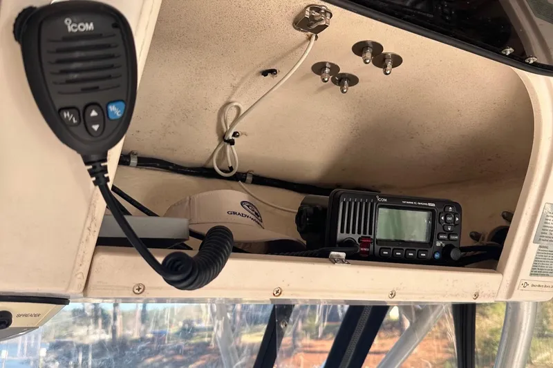 Slide: The Image of 2004 Grady-White Sailfish 282 WA boat interior with Icom radio equipment. - 13