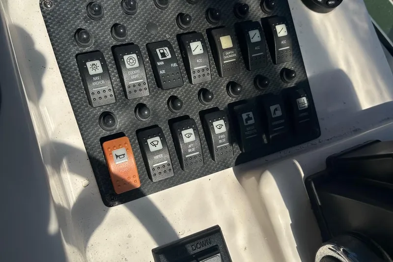 Slide: The Image of Control panel of a 2004 Grady-White Sailfish 282 WA boat with labeled switches. - 14
