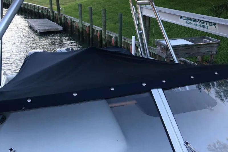 Slide: The Image of 2004 Grady-White Sailfish 282 WA boat docked with black cover. - 18