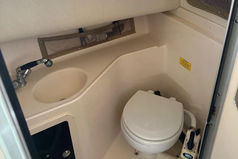 Slide: The Image of 2004 Grady-White Sailfish 282 WA boat bathroom with sink and toilet. - 23