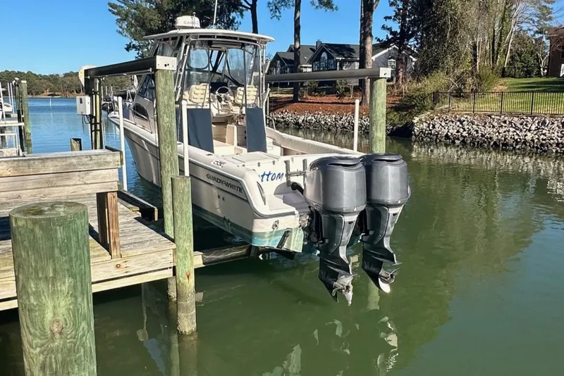 Slide: The Image of 2004 Grady-White Sailfish 282 WA boat docked with dual outboard motors. - 5