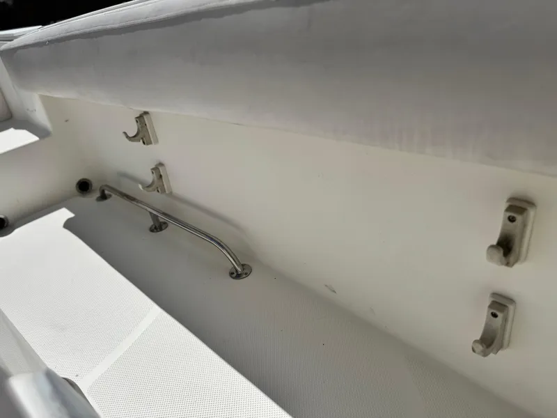 Slide: The Image of Interior view of a 2006 Bayliner 2503 Trophy Center Console boat, featuring rod holders. - 14