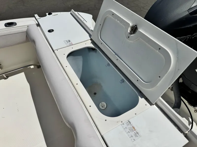 Slide: The Image of Open storage compartment on 2006 Bayliner 2503 Trophy Center Console boat. - 16
