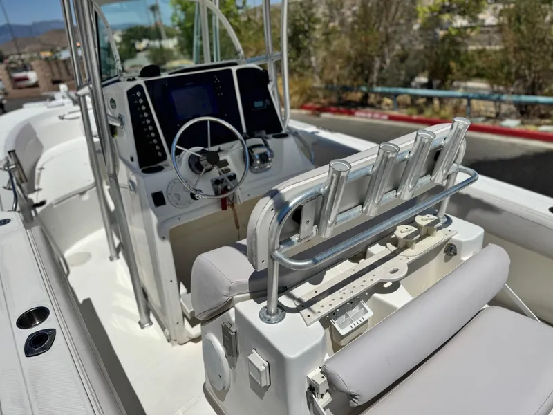 Slide: The Image of 2006 Bayliner 2503 Trophy Center Console boat interior with steering wheel and rod holders. - 18