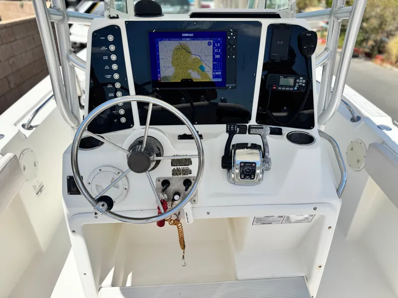Slide: The Image of 2006 Bayliner 2503 Trophy Center Console dashboard with steering wheel and navigation system. - 19