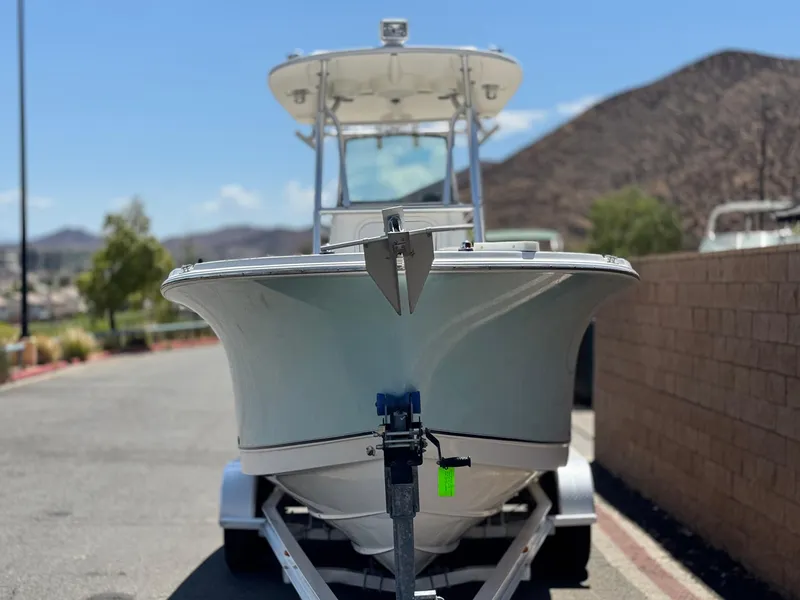 Slide: The Image of 2006 Bayliner 2503 Trophy Center Console boat on trailer, parked outdoors. - 2