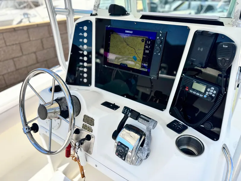 Slide: The Image of 2006 Bayliner 2503 Trophy Center Console dashboard with steering wheel and navigation equipment. - 20