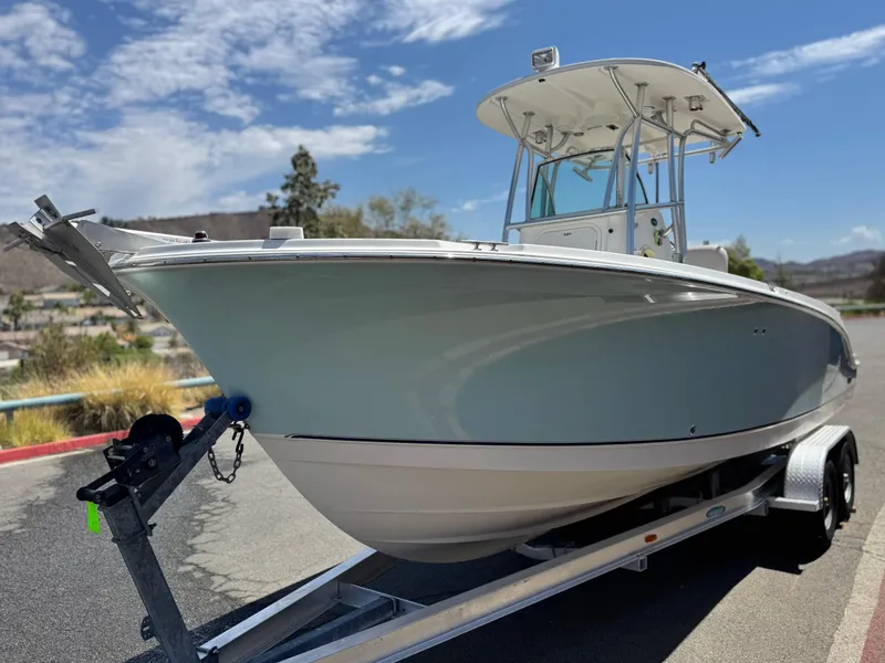 Slide: The Image of 2006 Bayliner 2503 Trophy Center Console boat on trailer under blue sky. - 3