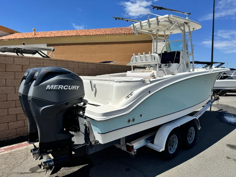 Slide: The Image of 2006 Bayliner 2503 Trophy Center Console boat with dual Mercury engines on a trailer. - 5