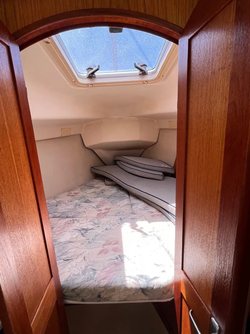 Slide: The Image of Cozy cabin interior of 2001 Hunter 320 sailboat with skylight and cushions. - 12