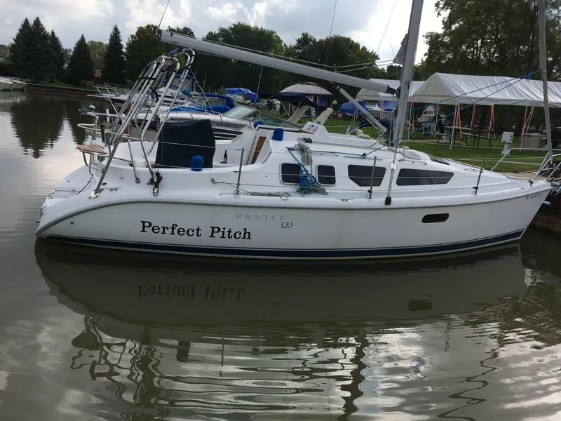 Slide: The Image of Hunter 320 sailboat named "Perfect Pitch" docked in a marina, 2001 model. - 3