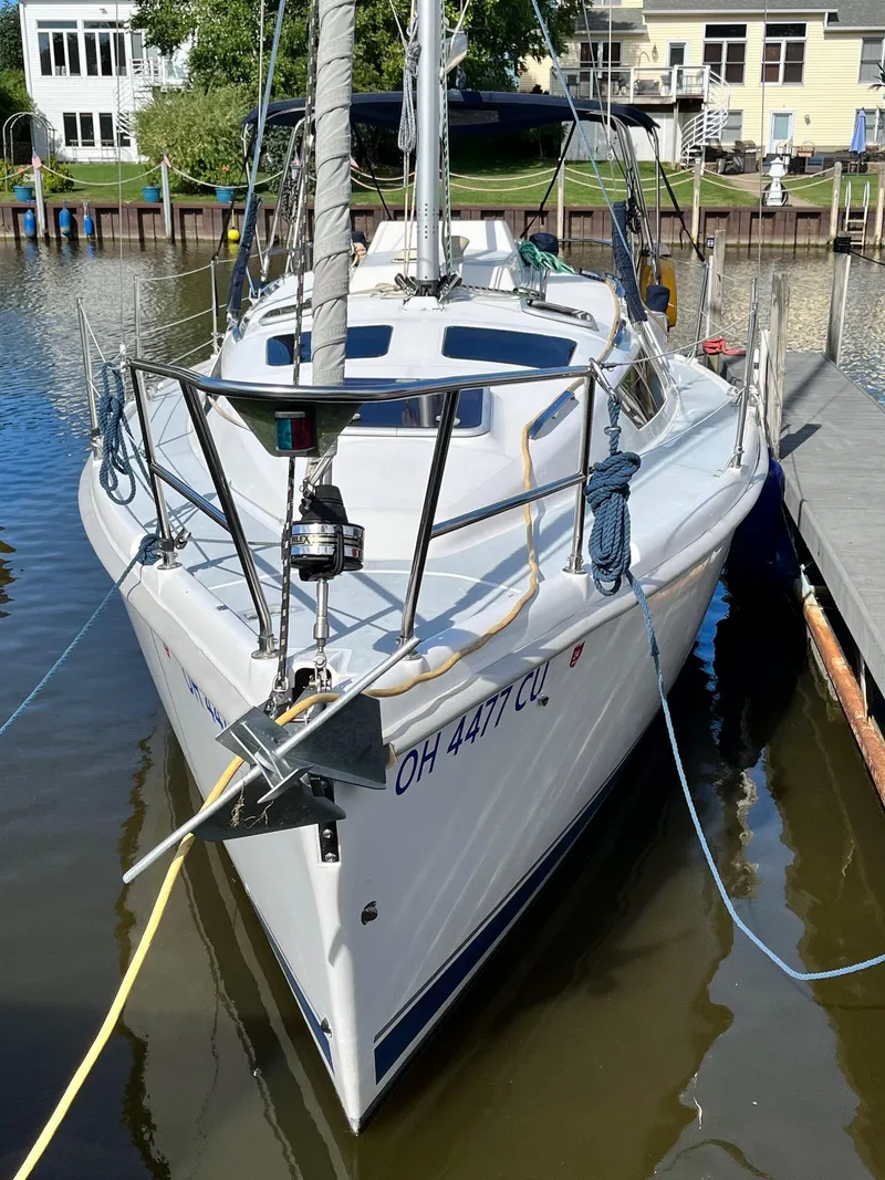 Slide: The Image of 2001 Hunter 320 sailboat docked in a marina, front view. - 4