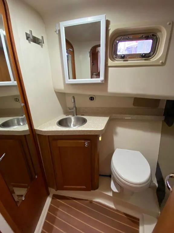 Slide: The Image of 2004 Mainship 340 yacht bathroom with sink, mirror, and toilet. - 11