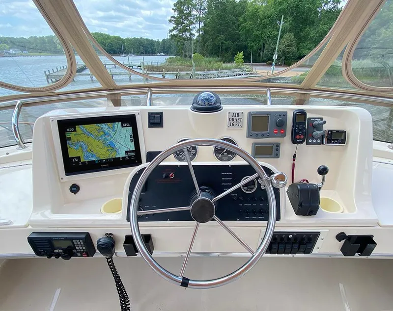 Slide: The Image of Helm of 2004 Mainship 340 boat with navigation equipment and steering wheel. - 15